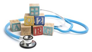 Stethoscope and wooden alphabet blocks.